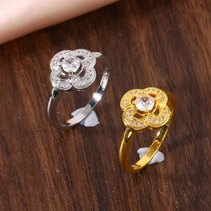 Detail view of gold and silver four-leaf clover rings with micro-pave zirconia stones