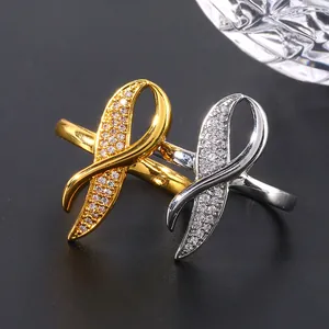 Elegant gold and silver crisscross rings with micro-paved cubic zirconia stones