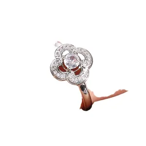 Silver-tone flower ring featuring micro-pave clover petals and a center moissanite stone