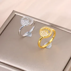Luxe gold and silver sun-moon rings with micro-pave zircons on a textured jewelry stand