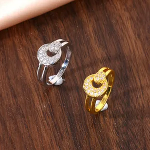 Detailed view of dual-ring sets with micro-pave zircons on a dark wood background