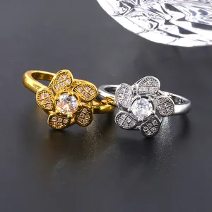 Luxury flower rings with micro-pave zircons in gold and silver finish on a dark surface