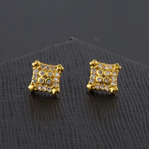 Macro shot of gold square stud earrings with heart corners and pave-set cubic zirconia