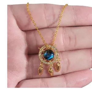 Golden dreamcatcher necklace with blue galaxy gemstone and micro-pave zircon feathers