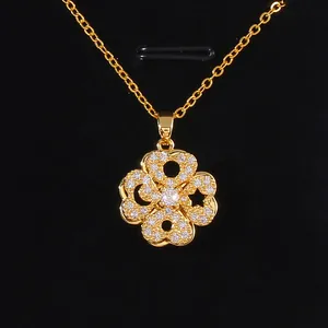 Rotating gold clover necklace with micro-pave zircons and delicate star cutouts