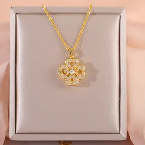 Close-up of golden clover pendant with zircon inlay in a premium jewelry box