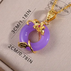 Detail view of purple jade pendant with gold floral inlay and zircon accents