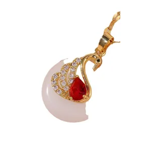 Elegant swan pendant necklace with red teardrop stone and zircon pave in gold finish