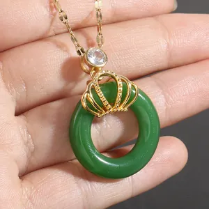 Elegant gold crown pendant necklace with a green jade-style ring and sparkling zircon