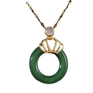 Elegant gold crown pendant necklace with dark green jade stone and zircon accents