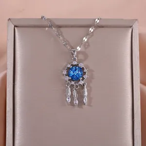 Silver dreamcatcher necklace with star blue stone and feather charms on satin