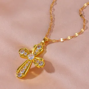 Golden hollow cross necklace with micro-paved zircons on a soft purple silk background