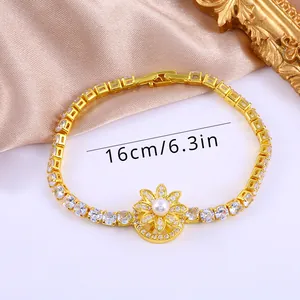 Détail d'un bracelet fleur de soleil doré de 16cm avec perle blanche et zircons fins