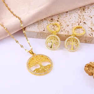 Close-up of gold tree of life jewelry set with sparkling pavé zircons on silk background