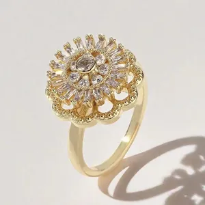 Macro shot of 360-degree rotating gold flower ring with cubic zirconia center