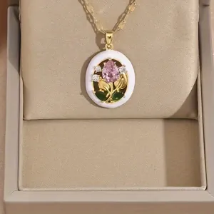 Macro detail of rose pendant necklace with pink pear-cut zircon and white enamel