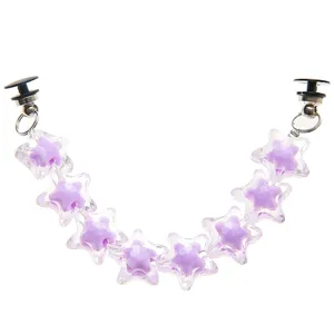 Macro shot of purple star acrylic shoe chain with durable black buckle fasteners