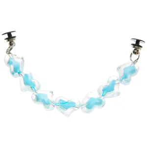 Macro detail of blue heart resin chain charms for clog shoes with plastic toggles