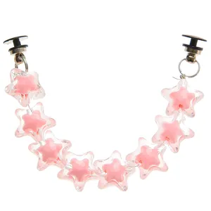 Detailed view of pink acrylic star chain shoe charms with black buckle clips for clogs
