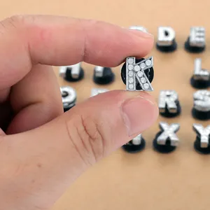 Close-up of sparkling rhinestone alphabet charms for shoes and DIY bracelets decoration
