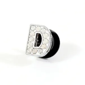 Close-up of letter D shoe charm with sparkling rhinestones and secure back pin