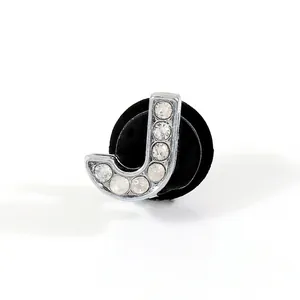 Close-up of a silver letter J shoe charm decorated with sparkling rhinestones for clogs