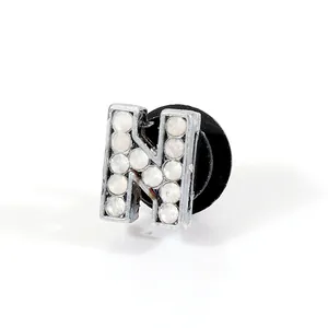 Detailed close-up of rhinestone letter N charm with silver metal frame for clog shoe