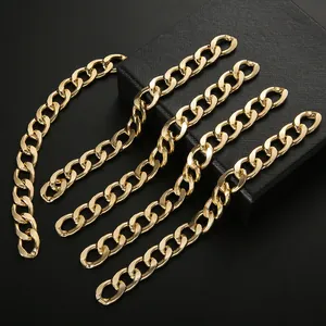 Detailed view of 13mm KC gold curb chains for DIY jewelry making on a black textured background