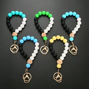 Detail of colorful silicone beaded keyrings with wood hexagon bead and gold lobster clasp
