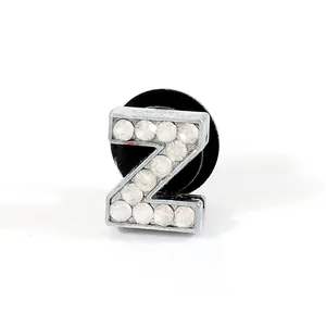 Detail of silver letter Z shoe charm with clear rhinestones and black fastener buckle