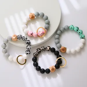Silicone beaded keychain bracelets in neutral tones with leopard print and hexagon wood beads