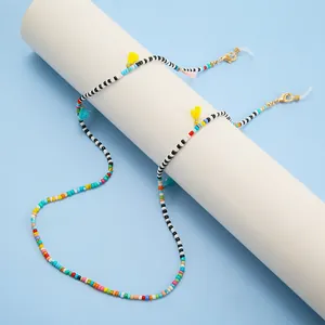 Dettaglio della catena per occhiali con perline colorate, nappe e passanti in silicone