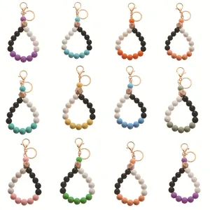 Collection of 12 silicone beaded wristlet keychains with wooden hexagonal beads in various colors