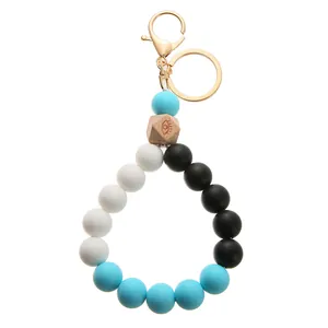 Detail of colorful silicone beads keyring with evil eye wooden bead and gold clasp