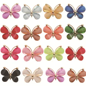 Macro view of colorful acrylic butterfly charms with gold metal edges for shoes