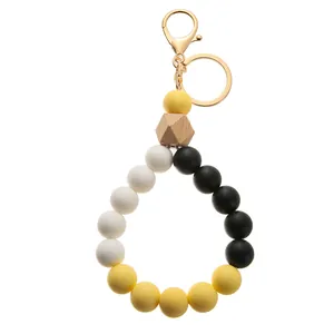 Detail view of silicone beaded keychain with black yellow beads and gold lobster clasp