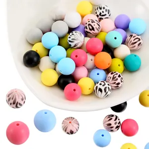 Macro detail of 15mm leopard print and pastel silicone beads for DIY jewelry making