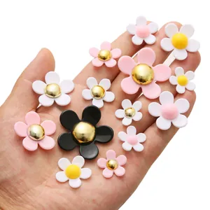 Macro view of multi-color resin daisy charms for DIY crafts and shoe decoration