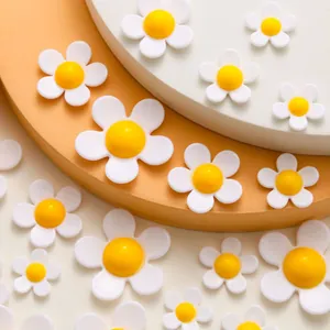 Detail of mixed-size resin daisy flower charms for shoes and DIY crafts decoration