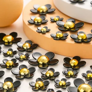 Macro shot of colorful resin flower charms with golden centers for DIY shoe and accessory decor
