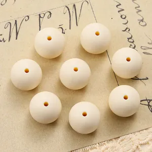 Close-up of eight cream white 15mm silicone round beads for DIY bracelet making
