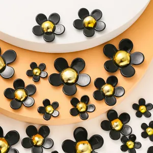 Black resin flower shoe charms with gold metal centers in various sizes for DIY crafts