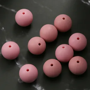 Macro view of 15mm soft pink silicone beads with smooth matte finish for DIY jewelry