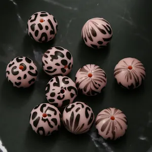 Detail of 15mm light pink leopard and zebra pattern silicone round beads for DIY bracelets