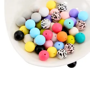 Colorful 15mm silicone leopard print beads for DIY bracelets on a white ceramic tray