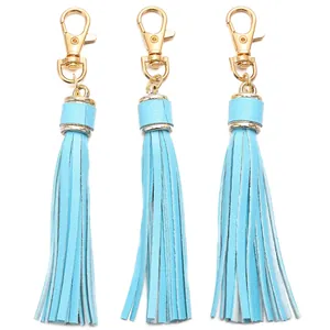 Three light blue faux leather tassels with bright gold lobster clasps for bags and keys