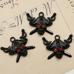 Macro shot of pirate skull charms with red rhinestone eyes and black enamel finish