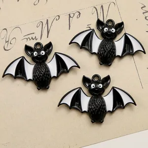 Detailed macro view of black and white bat charms for Halloween DIY jewelry making