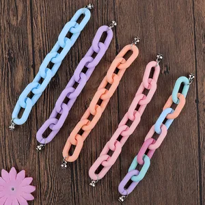 Colorful macaron resin chain straps with silver metal clasps on a wooden background