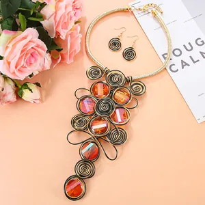 Detail von afrikanischem Schmuckset mit orangefarbenen Steinen und Spiralanhängern